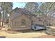 Rear view with a sunroom, wooden deck, and landscaped backyard at 245 Highview Trce, Fayetteville, GA 30215