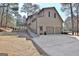 Rear exterior with a two-car garage, ramp access, a deck, and a glass enclosed patio at 245 Highview Trce, Fayetteville, GA 30215