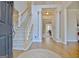 Elegant foyer with hardwood floors, staircase, and entry to dining area and living space at 245 Highview Trce, Fayetteville, GA 30215