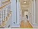 Classic foyer features hardwood floors, staircase with carpet runner, and decorative columns at 245 Highview Trce, Fayetteville, GA 30215