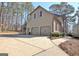 Side view of a home with a two-car garage and a concrete driveway at 245 Highview Trce, Fayetteville, GA 30215