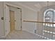 Upstairs hallway featuring an arched window and chandelier at 245 Highview Trce, Fayetteville, GA 30215