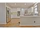 Spacious kitchen featuring stainless steel appliances, white cabinetry, and hardwood floors at 245 Highview Trce, Fayetteville, GA 30215