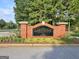 Community sign with a brick base, manicured plants, and mature trees at 245 Highview Trce, Fayetteville, GA 30215