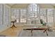 Sun-drenched sunroom with large windows, hardwood floors, and inviting decor at 245 Highview Trce, Fayetteville, GA 30215