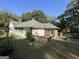 View of the rear of the home, featuring a wooden deck and screened-in porch at 3 Elm St, Porterdale, GA 30014