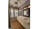 Spacious bathroom featuring double vanities, wood-look flooring, and great natural lighting at 3 Elm St, Porterdale, GA 30014