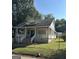 Charming bungalow featuring a cozy front porch and fenced yard at 3 Elm St, Porterdale, GA 30014