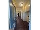 Hallway showcasing wood-look floors and built in cabinet storage at 3 Elm St, Porterdale, GA 30014