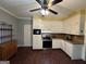 Eat-in kitchen featuring stainless steel appliances, wood-look floors, and a ceiling fan at 3 Elm St, Porterdale, GA 30014