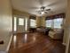 Living room showcasing hardwood floors, ceiling fan, and ample natural light at 3 Elm St, Porterdale, GA 30014