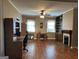 Spacious living room with hardwood floors, fireplace, ceiling fan and natural light at 3 Elm St, Porterdale, GA 30014