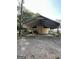 View of outbuilding with a metal roof, fenced in area, and covered parking at 3 Elm St, Porterdale, GA 30014