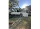Exterior view of the metal outbuilding with a fenced area at 3 Elm St, Porterdale, GA 30014