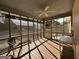 Interior of screened-in porch featuring wood floors and natural light at 3 Elm St, Porterdale, GA 30014