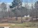 Large backyard featuring mature trees, an outbuilding, and a swing set at 1029 Hines Rd, Moreland, GA 30259