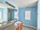 Bright bathroom with a large mirror, vanity, and a combined shower and bathtub for convenience at 1029 Hines Rd, Moreland, GA 30259