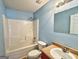 Cozy bathroom with a shower-tub combo, single sink vanity, and a neutral color scheme at 1029 Hines Rd, Moreland, GA 30259