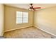 Neutral bedroom featuring a ceiling fan, carpet, and natural light from the window at 1029 Hines Rd, Moreland, GA 30259