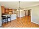 Open concept dining area with access to the kitchen and living spaces, featuring hardwood floors at 1029 Hines Rd, Moreland, GA 30259