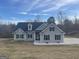 Charming single-story home with gray siding, black shutters, and a well-maintained front yard at 1029 Hines Rd, Moreland, GA 30259