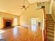 Cozy living room with a fireplace, hardwood floors, and a view into the dining area showcases an open floor plan at 1029 Hines Rd, Moreland, GA 30259