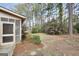 The backyard features trees, shrubbery, and the screened-in porch at 105 Jasper Dr, Stockbridge, GA 30281