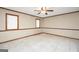 Spacious bedroom featuring neutral walls, wood trim, and natural light from the two windows at 105 Jasper Dr, Stockbridge, GA 30281