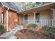 Inviting covered porch with white railings and brick accents at 105 Jasper Dr, Stockbridge, GA 30281