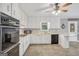 Inviting kitchen with white cabinets, stainless steel appliances, and views to the adjacent dining area at 105 Jasper Dr, Stockbridge, GA 30281