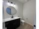Cozy bathroom with a black vanity, modern sink and toilet with wooden flooring at 349 Lowbrooke Ct # 19, Fairburn, GA 30213