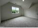 Bright, carpeted bedroom with a large window showcasing a beautiful green view at 349 Lowbrooke Ct # 19, Fairburn, GA 30213