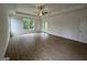 Bedroom with wood floors, a ceiling fan, and windows that provide a view of the yard at 349 Lowbrooke Ct # 19, Fairburn, GA 30213