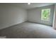 Spacious carpeted bedroom with plenty of natural light from the large window at 349 Lowbrooke Ct # 19, Fairburn, GA 30213