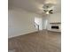 Bright living room with hardwood floors, ceiling fan, fireplace, and stairs to the second floor at 349 Lowbrooke Ct # 19, Fairburn, GA 30213