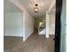 Bright living room with hardwood floors and a modern lighting fixture at 349 Lowbrooke Ct # 19, Fairburn, GA 30213
