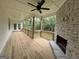 View of a covered porch with a stone fireplace, wooden floors and railing, and a ceiling fan at 349 Lowbrooke Ct # 19, Fairburn, GA 30213