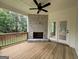 Image showing a covered porch with a stone fireplace, wood flooring, and doors leading inside at 349 Lowbrooke Ct # 19, Fairburn, GA 30213
