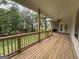 Covered porch with wood flooring, railing, ceiling, and a view of the surrounding trees at 349 Lowbrooke Ct # 19, Fairburn, GA 30213