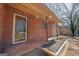 Welcoming brick home featuring a glass front door, well-maintained landscaping and a covered entrance at 260 Appalachee Church Rd, Auburn, GA 30011