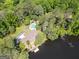 Aerial view of a house on a lake with pool surrounded by wooded acreage at 127 Hamby Ln, Social Circle, GA 30025