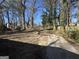 Large backyard with a mix of trees and open space, with a driveway at 1457 Richland Sw Rd, Atlanta, GA 30310