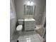 Bathroom with a decorative sink vanity with mirror, and a tiled floor at 1457 Richland Sw Rd, Atlanta, GA 30310