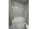 Tiled bathroom showcasing a tub shower combination and white tile flooring at 1457 Richland Sw Rd, Atlanta, GA 30310