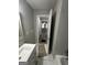 Bathroom showcasing a tub, vanity, and partial view into connecting rooms with neutral colors at 1457 Richland Sw Rd, Atlanta, GA 30310