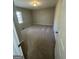 Cozy bedroom featuring neutral carpet, a window, and a white door at 1457 Richland Sw Rd, Atlanta, GA 30310