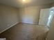 Spacious bedroom with carpet flooring, window, and white door at 1457 Richland Sw Rd, Atlanta, GA 30310