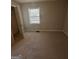 Empty bedroom with neutral carpet, window, and closet space at 1457 Richland Sw Rd, Atlanta, GA 30310