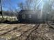 Back exterior of home with gray siding and an unfinished yard at 1457 Richland Sw Rd, Atlanta, GA 30310