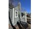 Side of home with gray siding, brick chimney and covered porch at 1457 Richland Sw Rd, Atlanta, GA 30310